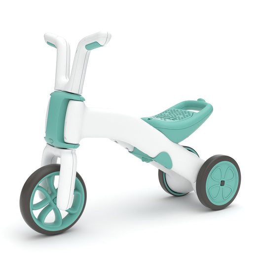 Children's tricycle with teal and white design on a white background