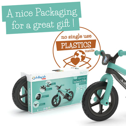 Children's balance bike with packaging and text about plastic-free design