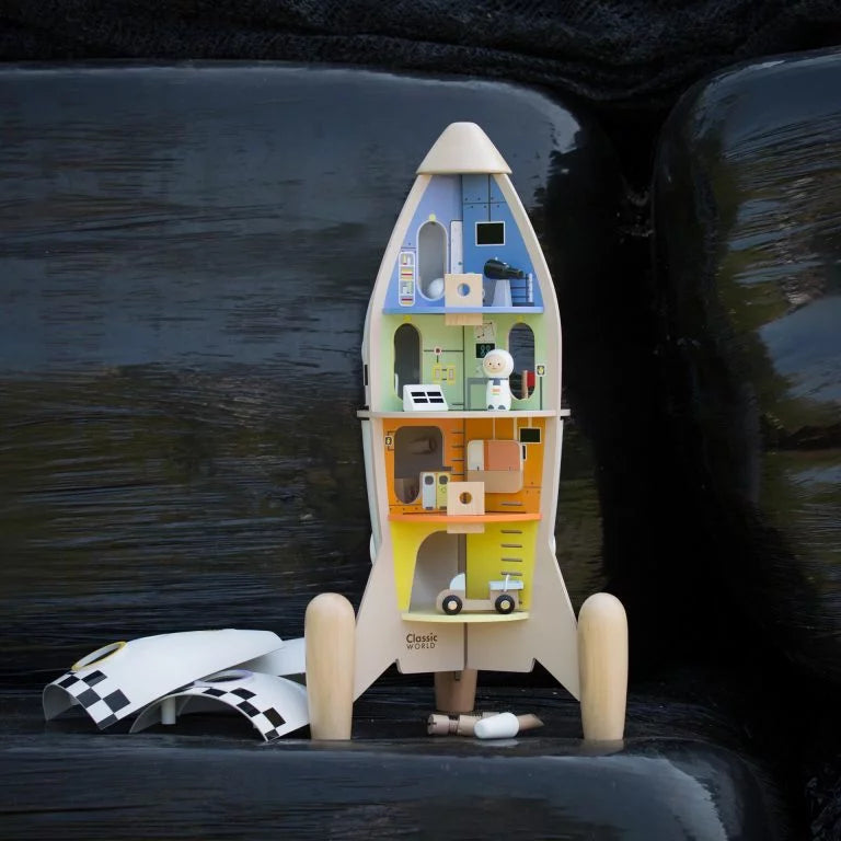 Toy rocket with multiple levels and small figures on a dark textured background