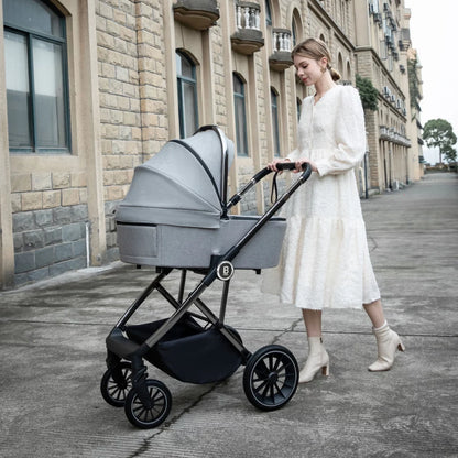 Woman pushing a stroller with a baby bassinet on a city street.