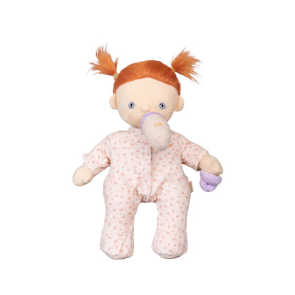 Stuffed doll with red hair in pigtails wearing a pink outfit on a white background