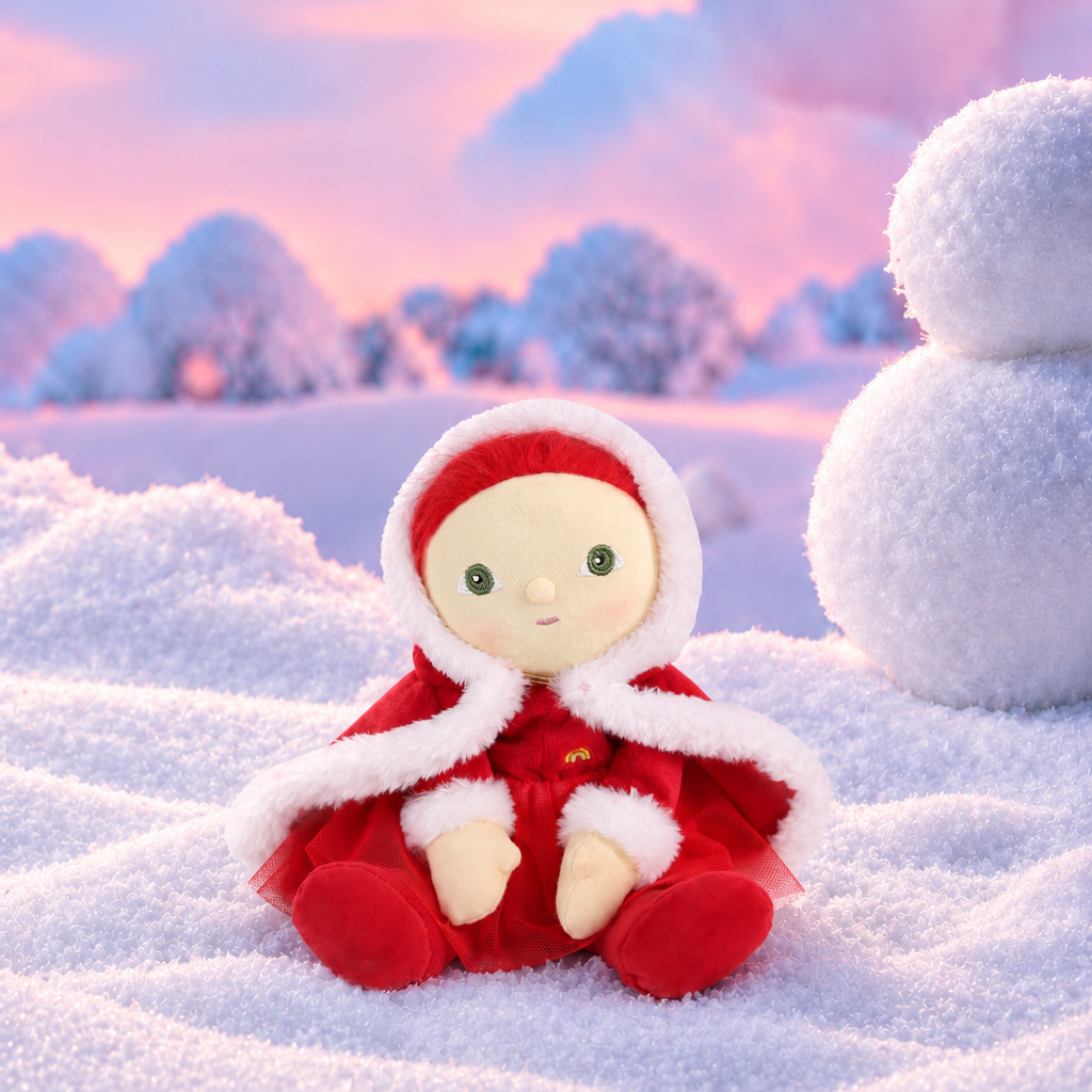 red doll with a snow and snowman background.