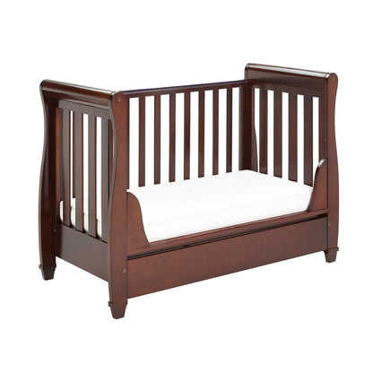 Wooden crib with white mattress on a white background