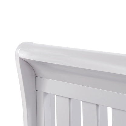 Close-up of a white crib with a plain background