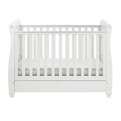 White crib with a white mattress on a white background
