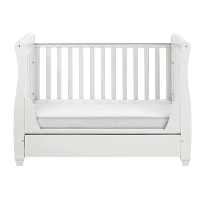 White crib with mattress on a white background