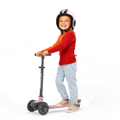 Child riding a scooter with a helmet on a white background