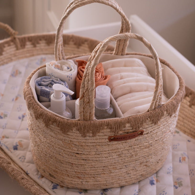 Woven basket with baby care items on a crib