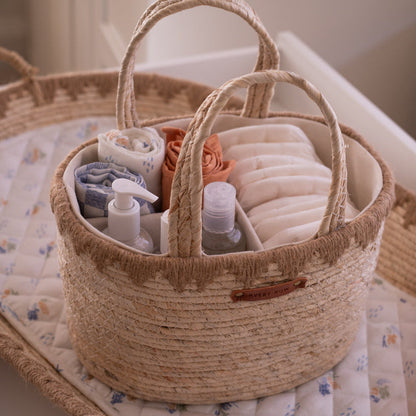 Woven basket with baby care items on a crib