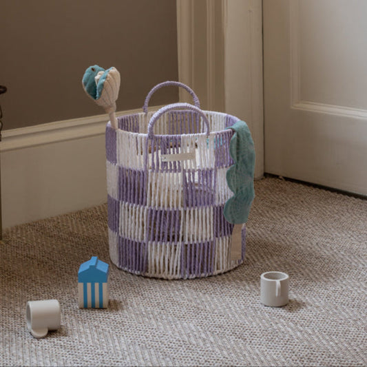 Woven basket with toys on a carpeted floor