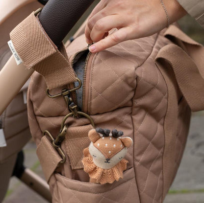 Stuffed animal keychain attached to a brown quilted bag
