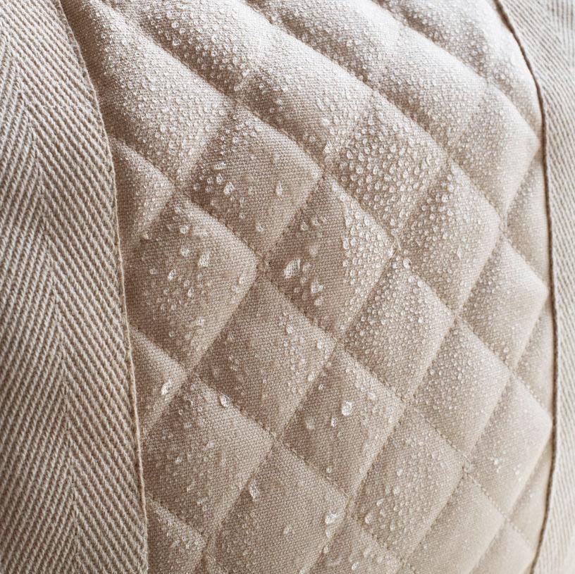 Close-up of a textured beige fabric with diamond pattern