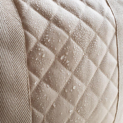 Close-up of a textured beige fabric with diamond pattern