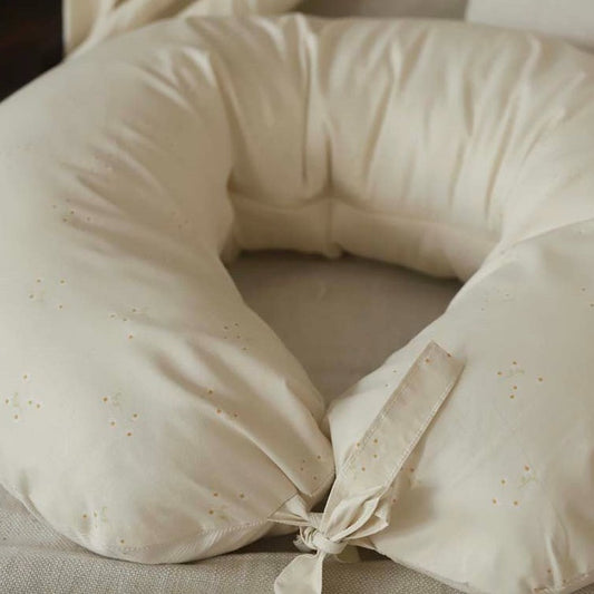 Beige neck pillow with a subtle pattern on a neutral background