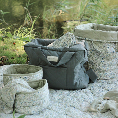 Quilted fabric bags on a stone surface with a natural background