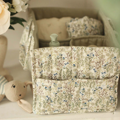 Floral-patterned storage basket with baby items on a light surface