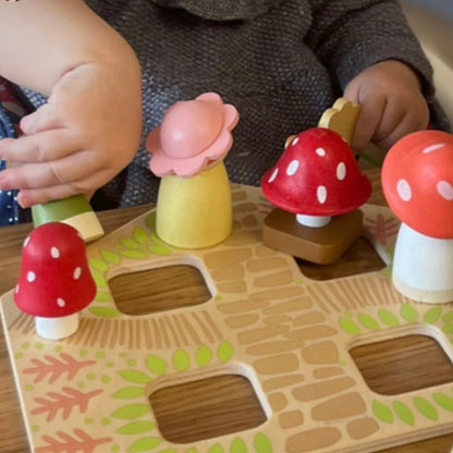 Children playing with a mushroom-shaped educational toy on a wooden board.