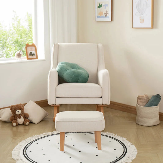 White armchair with a green cushion in a room with a teddy bear and a rug.