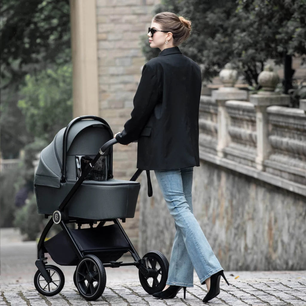 Woman pushing a black stroller in an urban setting