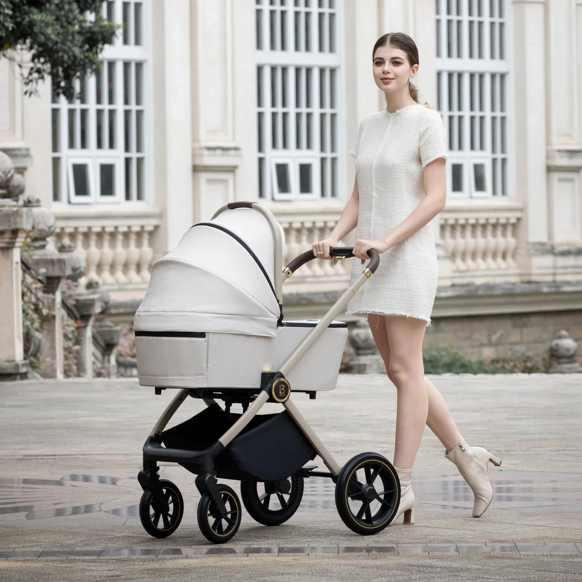 Woman pushing a baby stroller in an elegant outdoor setting