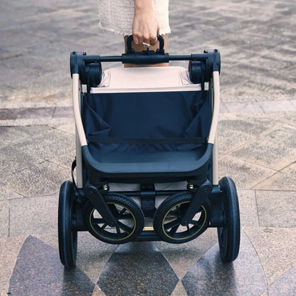 Stroller with navy cover on a paved surface