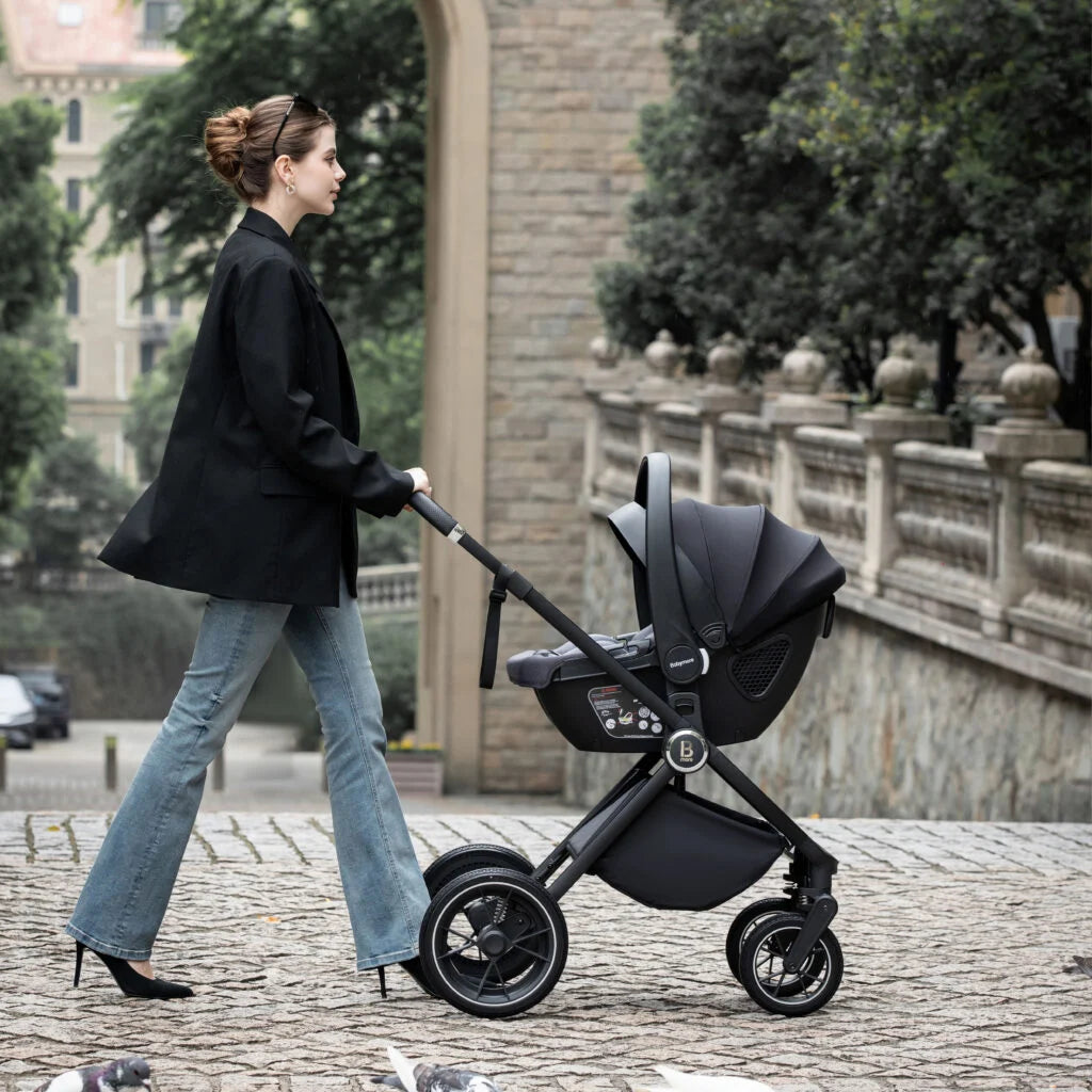 Woman pushing a black stroller in an urban setting