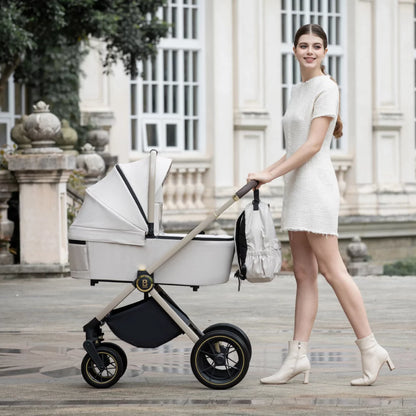 Woman in a white dress pushing a baby stroller in an elegant outdoor setting