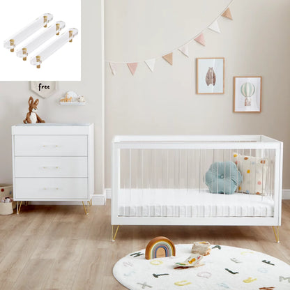 Nursery room with white crib, dresser, and decorative elements.