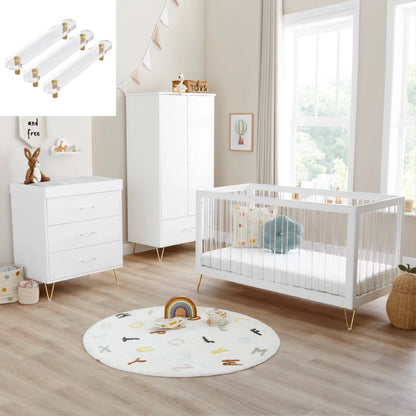 Nursery room with white crib, dresser, and round rug on wooden floor.