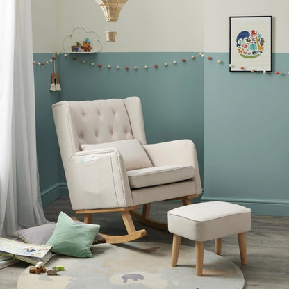 Beige armchair and ottoman in a room with teal walls and decorative elements.