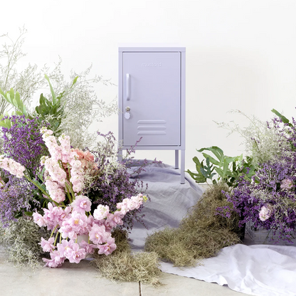 Small purple locker with floral arrangements on a white background