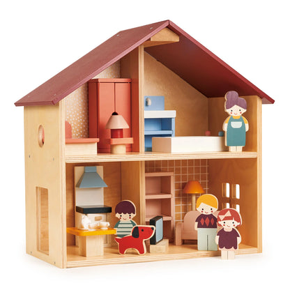 Wooden dollhouse with furniture and dolls on a white background