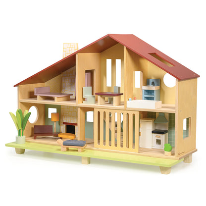 Wooden dollhouse with furniture on a white background
