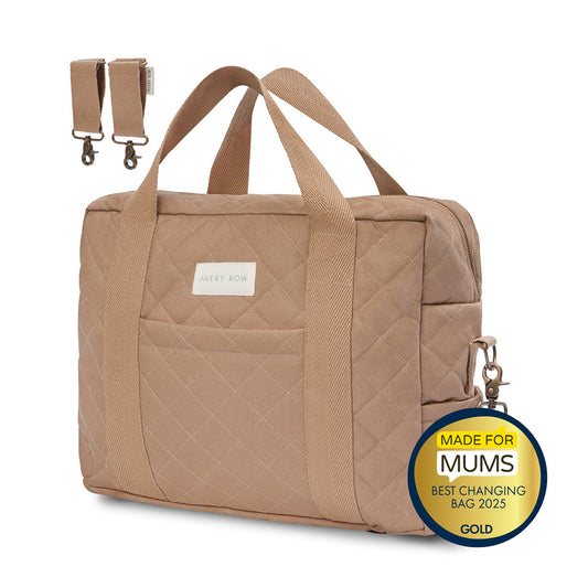 Brown quilted changing bag with a gold badge on a white background