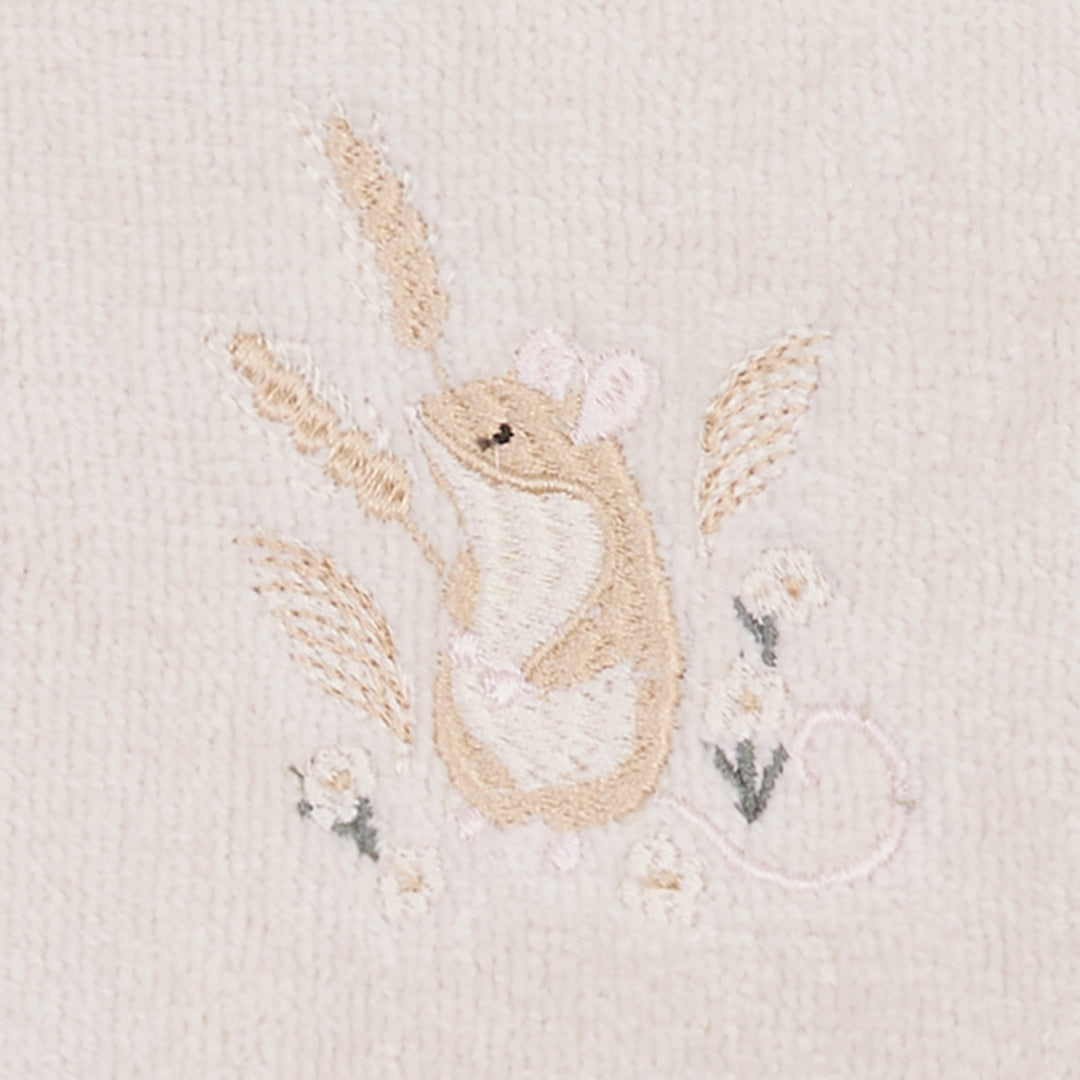 Embroidered design of a mouse and flowers on a textured fabric background