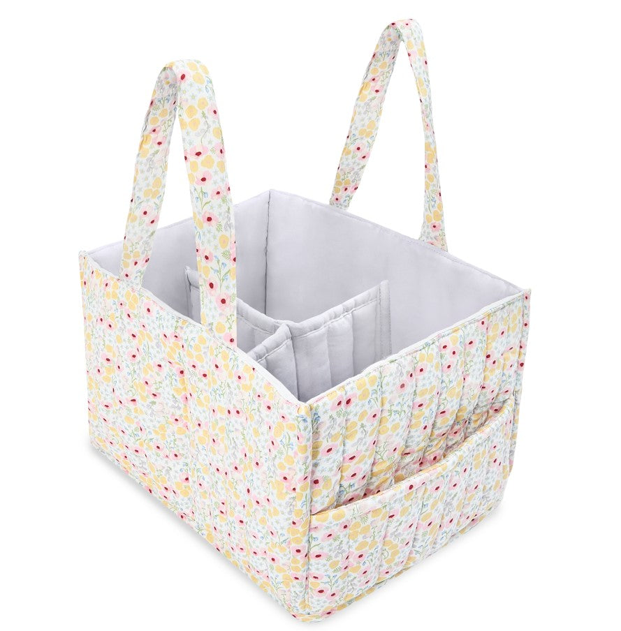Fabric storage caddy with floral handles on a white background