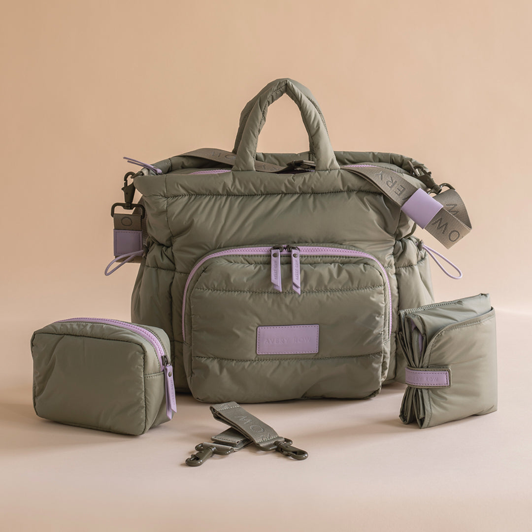 Green travel bag with purple accents on a beige background