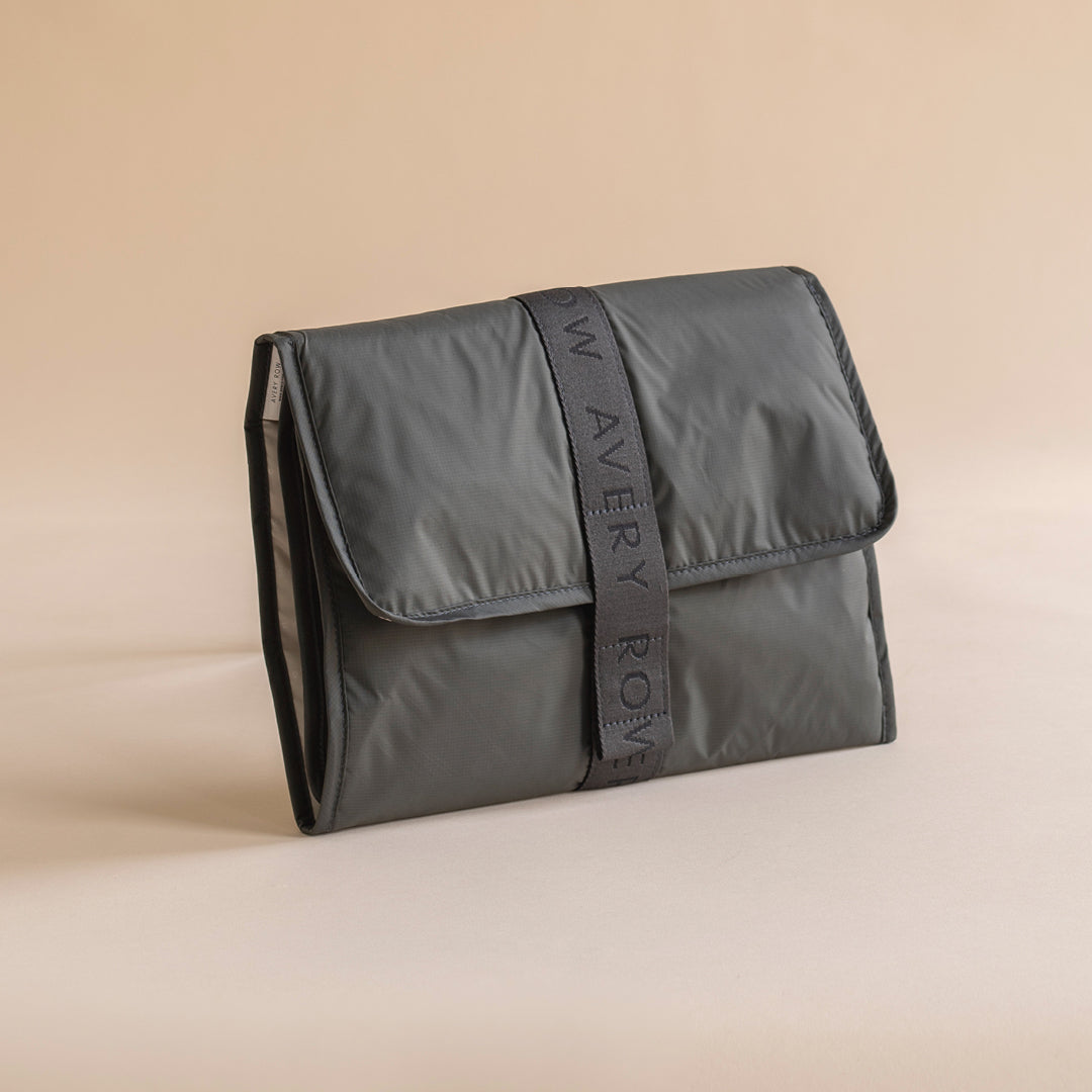 Gray pouch with 'Wavery Row' branding on a beige background