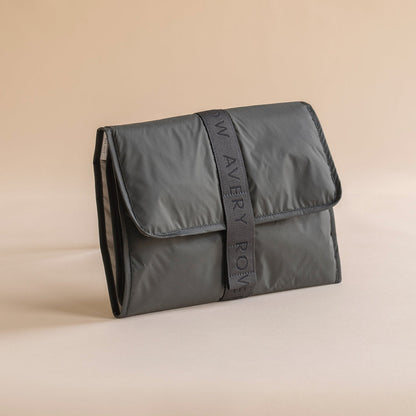 Gray pouch with 'Wavery Row' branding on a beige background