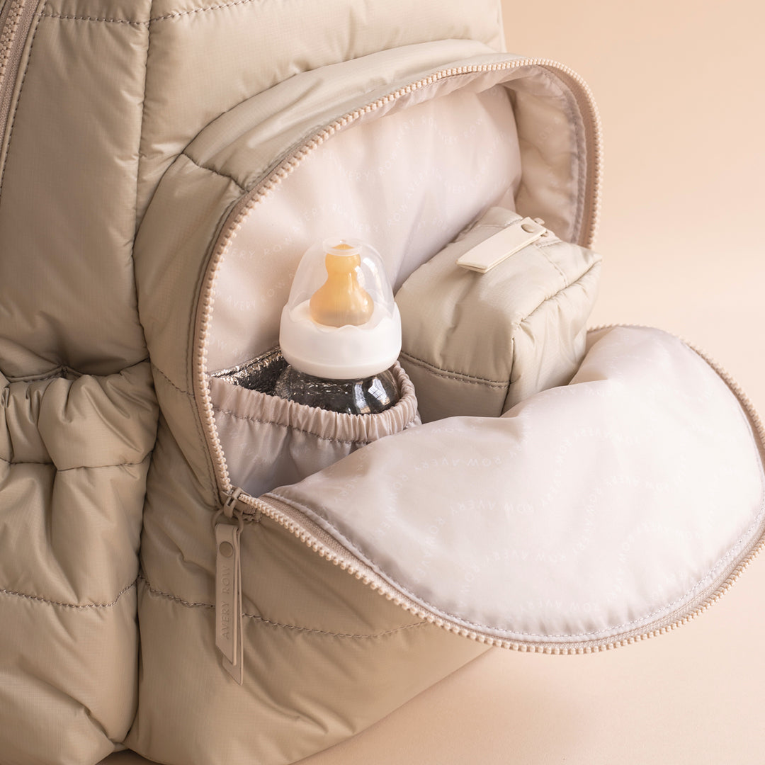 Baby bottle inside a beige quilted bag
