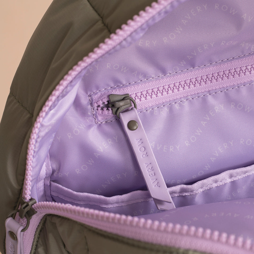 Close-up of a purple zipper on a bag with 'Every Row' branding.