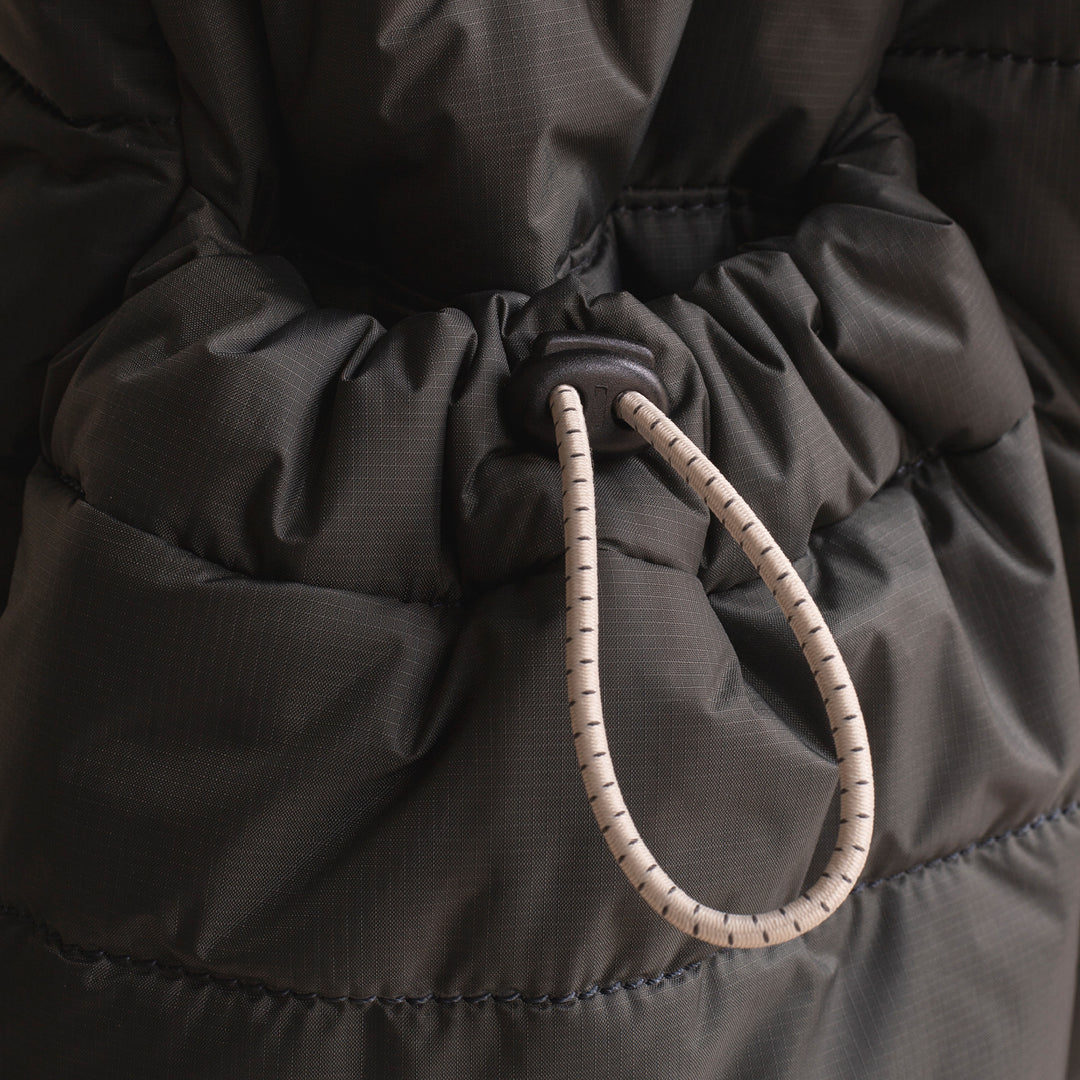 Close-up of a dark gray puffer jacket with drawstring hood