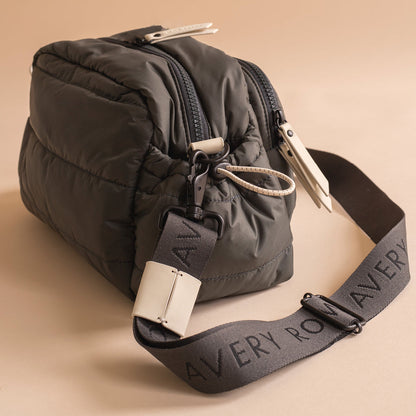 Dark gray bag with a strap on a beige background