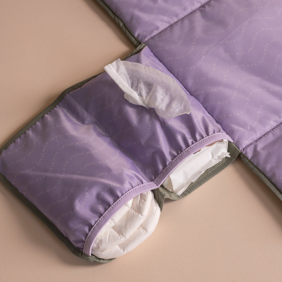 Purple quilted cover with white interior on a beige surface