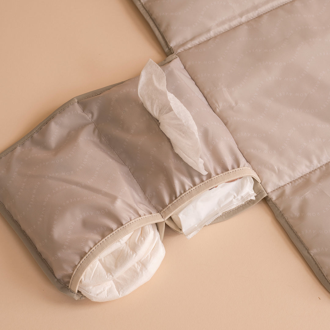 Folded beige quilt on a beige surface