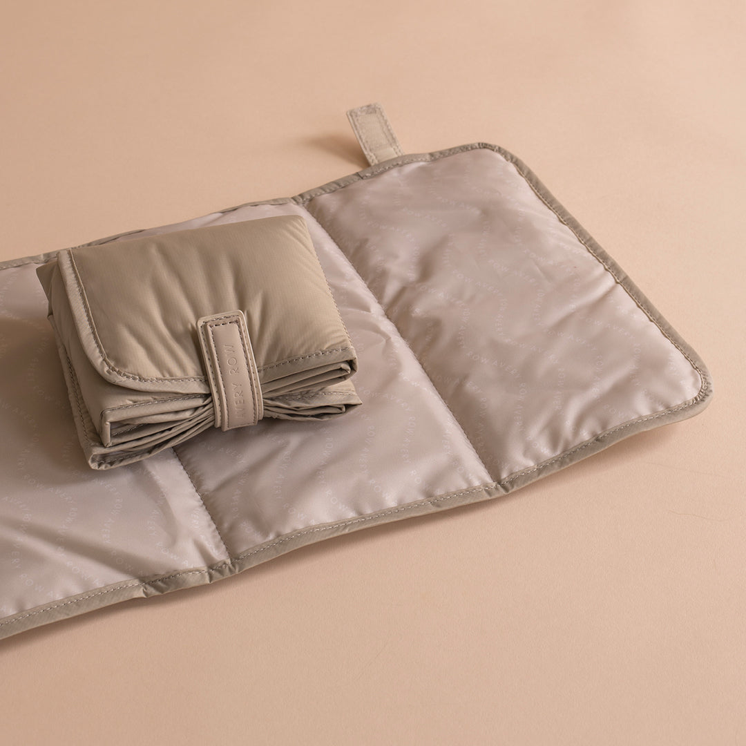 Folded beige fabric mat on a beige background
