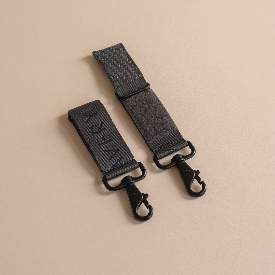 Black strap with clasp on a beige background
