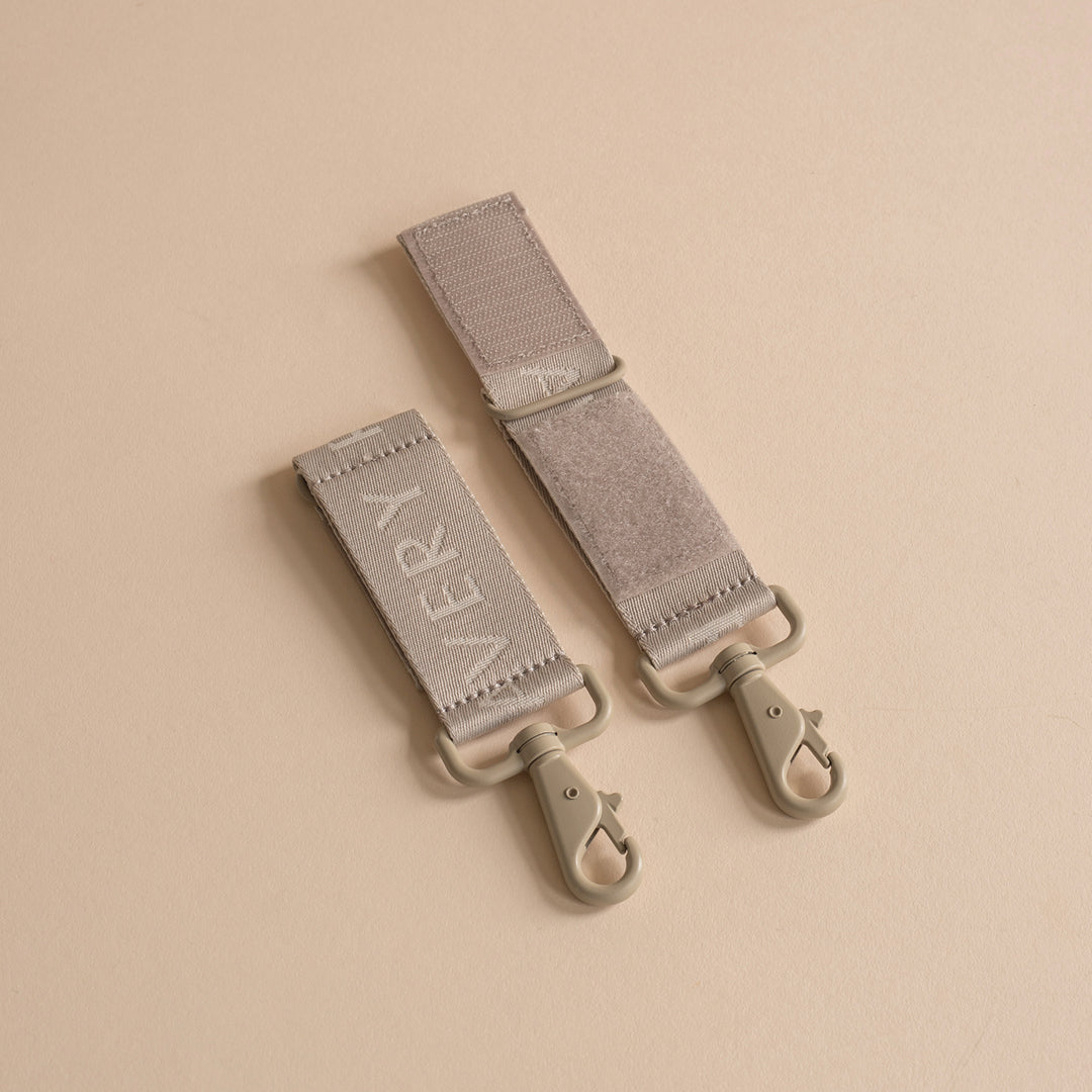 Two gray straps with 'Every' branding on a beige background