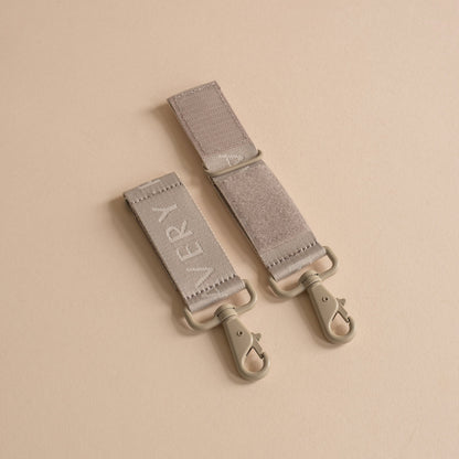 Two gray straps with 'Every' branding on a beige background