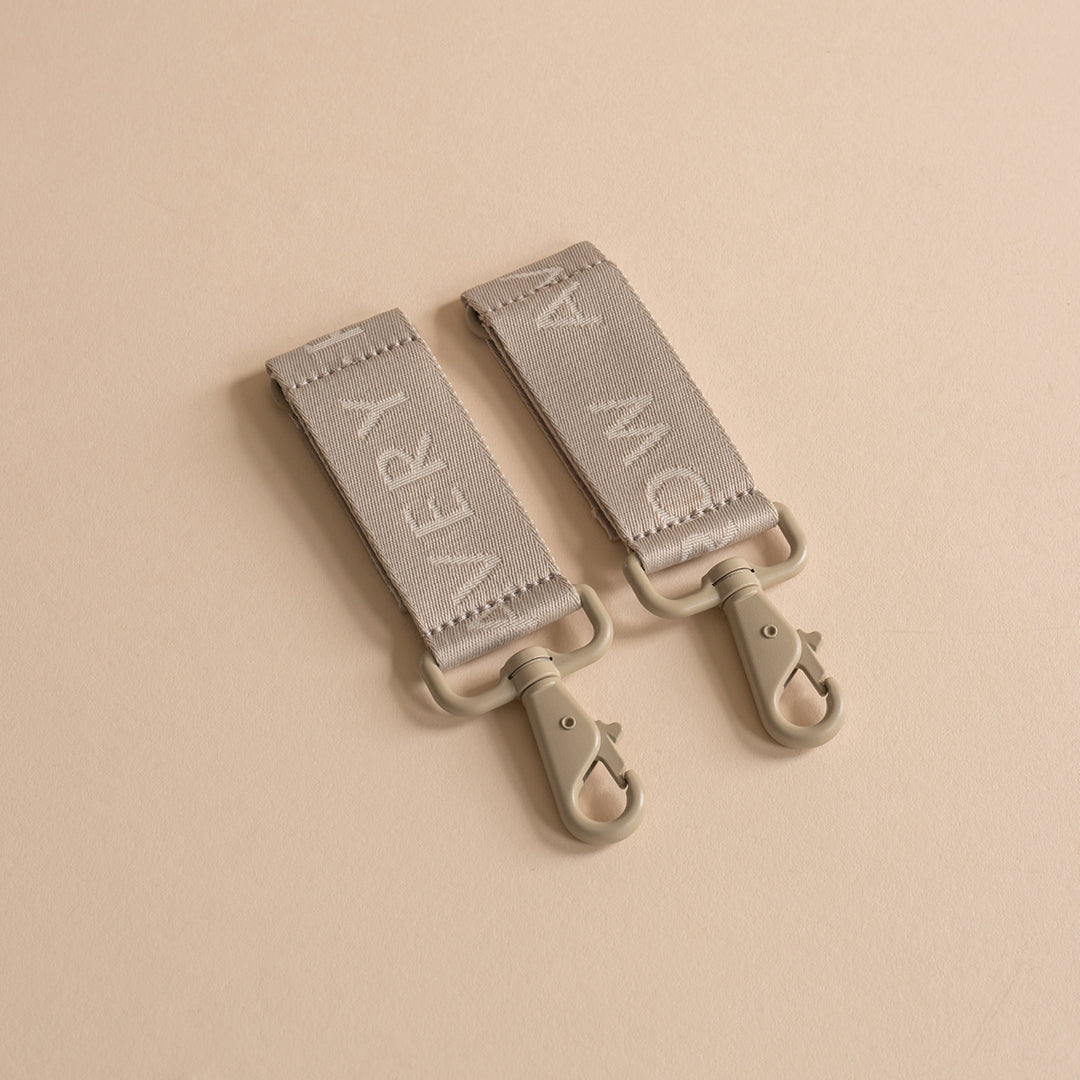 Two gray straps with text on a beige background